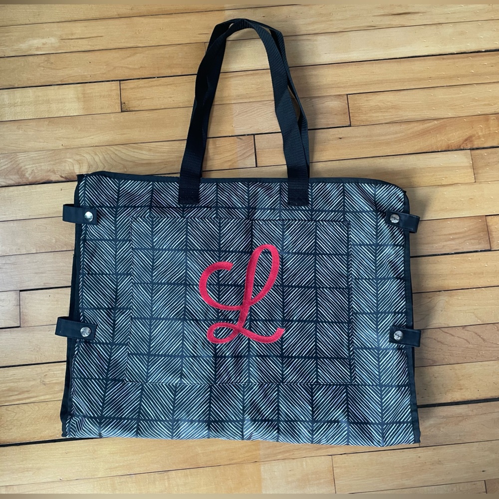 Brand New Well Suited Garment Bag by Thirty-One with red “L” on front.